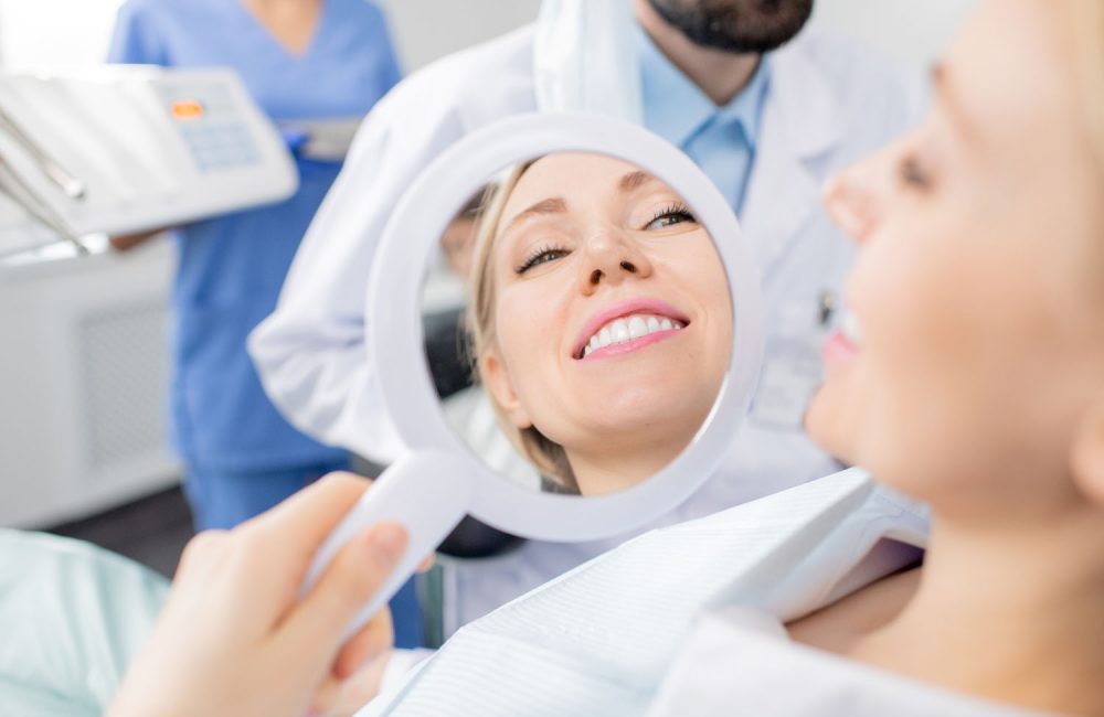 reflection-mirror-healthy-smile-pretty-young-smiling-female-patient-dental-clinics-after-whitening-teeth-procedure-by-her-dentist.jpg